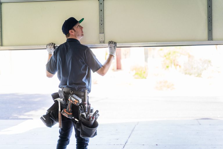 Garage door professional fixing garage door panels.